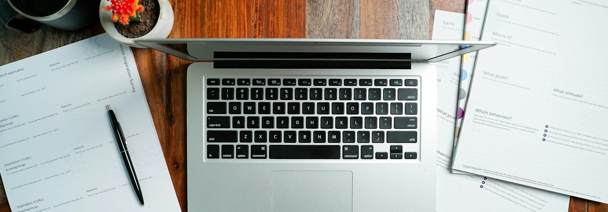 Laptop and invoices on a desk
