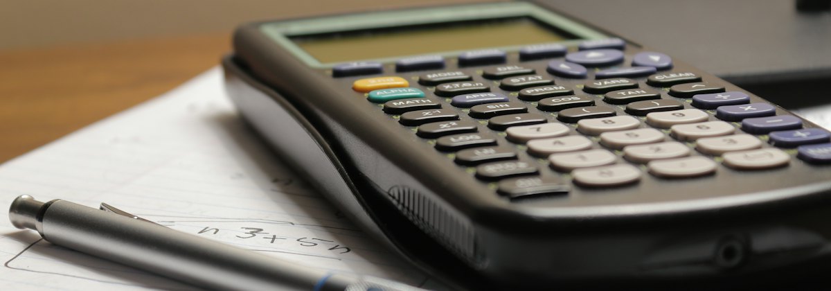 Calculator and pen on financial documents