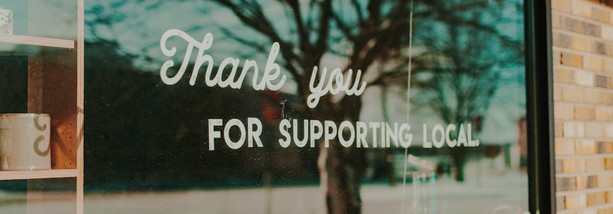 Shop window reading Thank you for supporting local